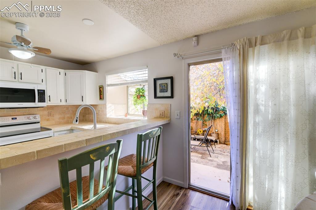 Image 21 of 25: Walkout to fully fenced back patio