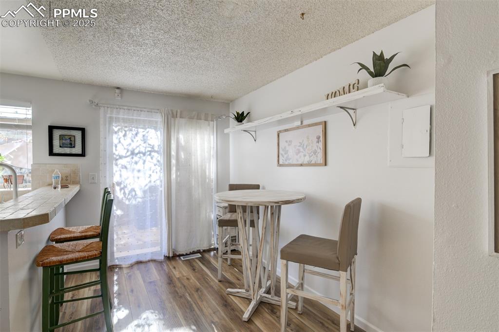 Image 5 of 25: Dining area on the main level featuring wood-style flooring and a walk out 