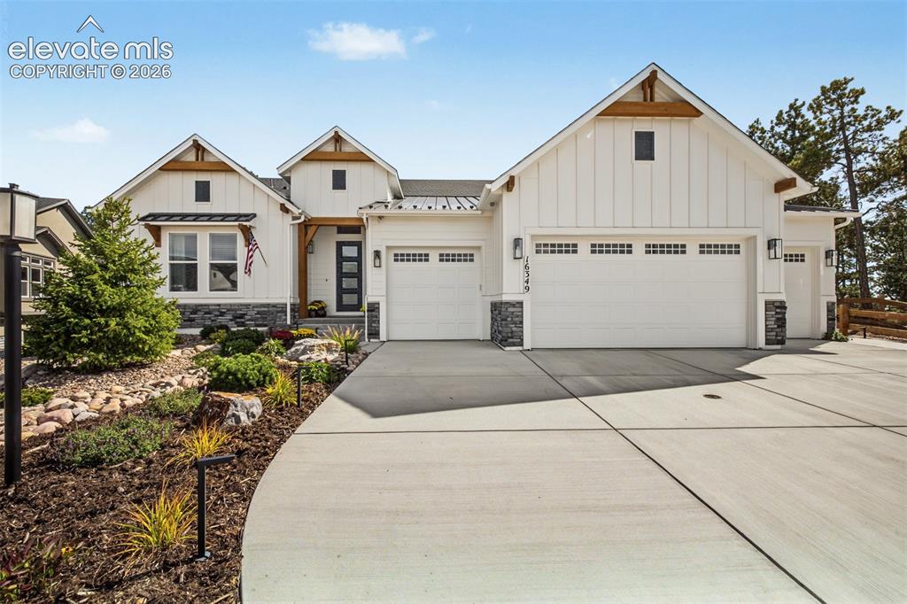 Image 1 of 50: Beautiful curb appeal featuring attractive stone accents, professional land
