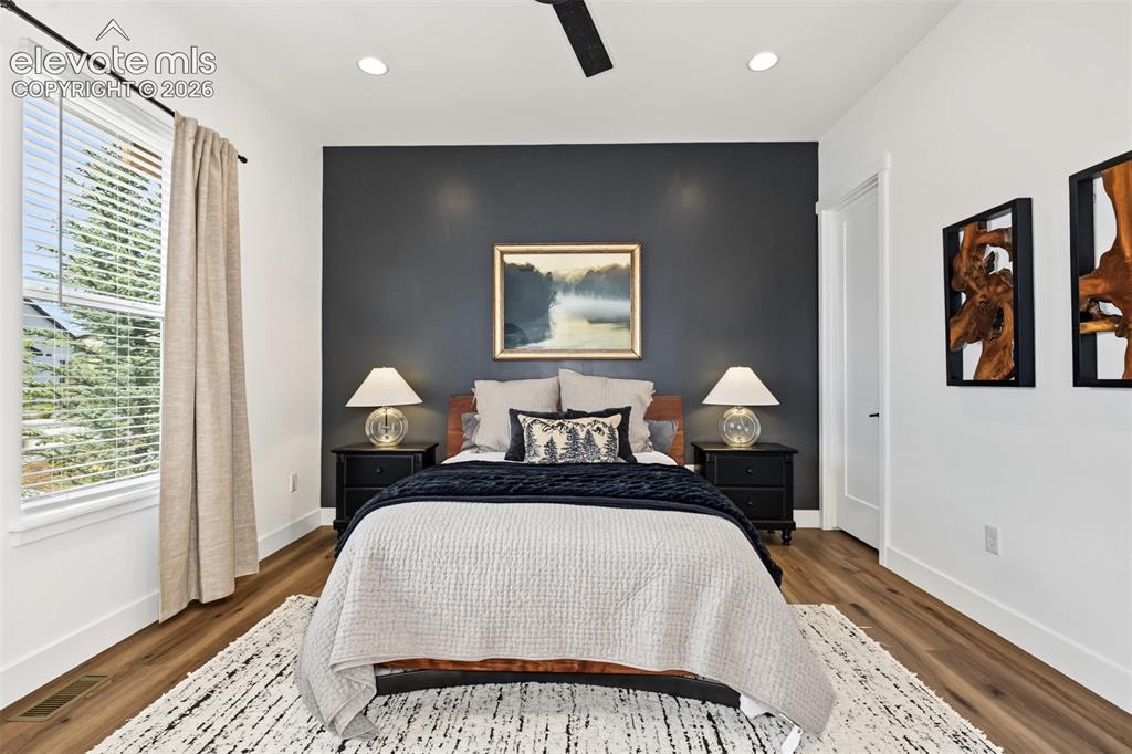 Image 23 of 50: Spacious secondary bedroom featuring abundant natural light, large windows,
