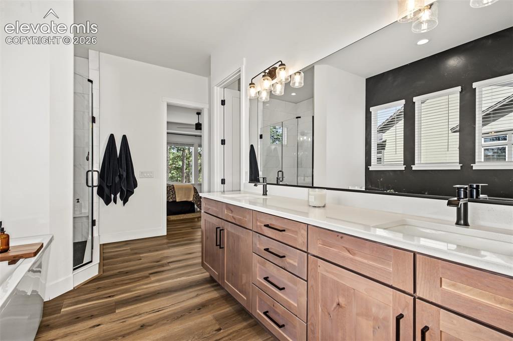 Image 30 of 50: Beautifully appointed primary bathroom featuring an expansive dual-sink van