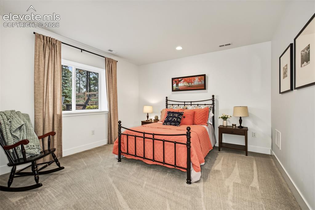 Image 39 of 50: Carpeted flooring, recessed lighting, and a white window frame