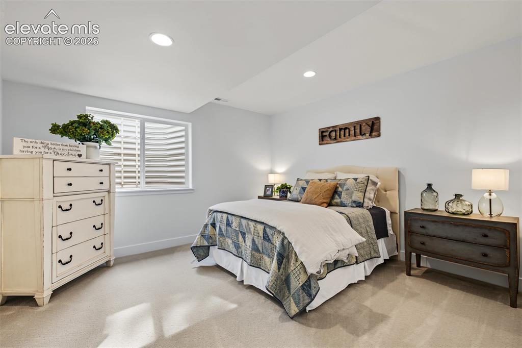 Image 41 of 50: Recessed lighting, light-colored walls, and carpeted flooring