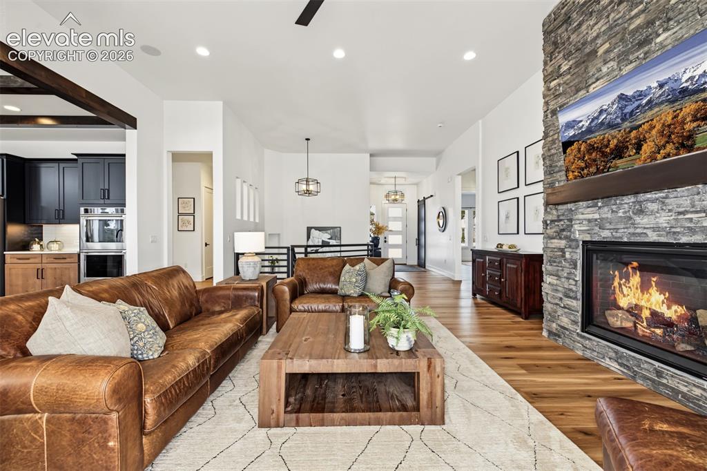 Image 8 of 50: Stunning great room featuring soaring ceilings, expansive windows, and a dr