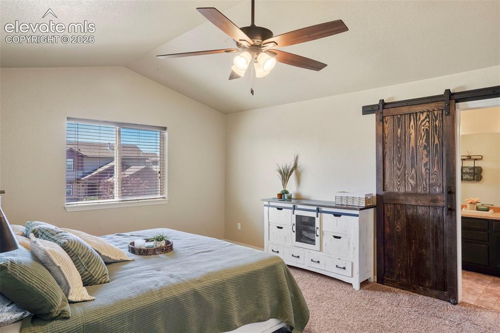Image 13 of 32: Vaulted ceiling with ceiling fan, window with horizontal blinds, wood-finis