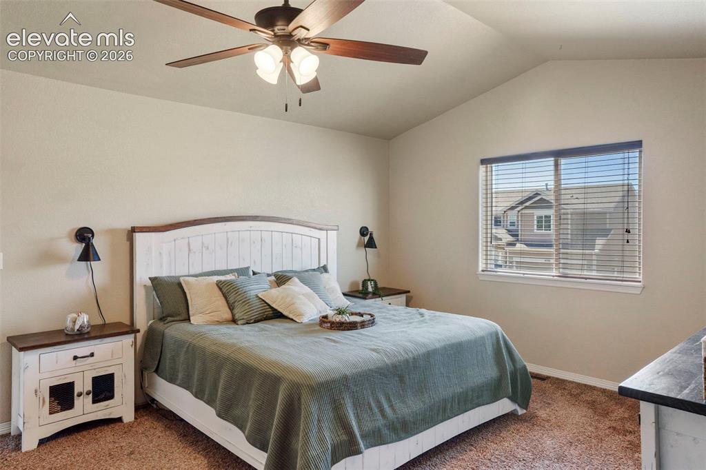 Image 14 of 32: Vaulted ceiling featuring a ceiling fan with integrated lighting, a large w