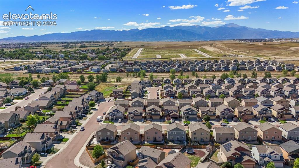 Image 26 of 32: Expansive residential neighborhood with distant mountain range