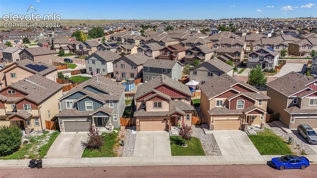 Image 27 of 32: Suburban neighborhood with diverse architectural styles and attached garage