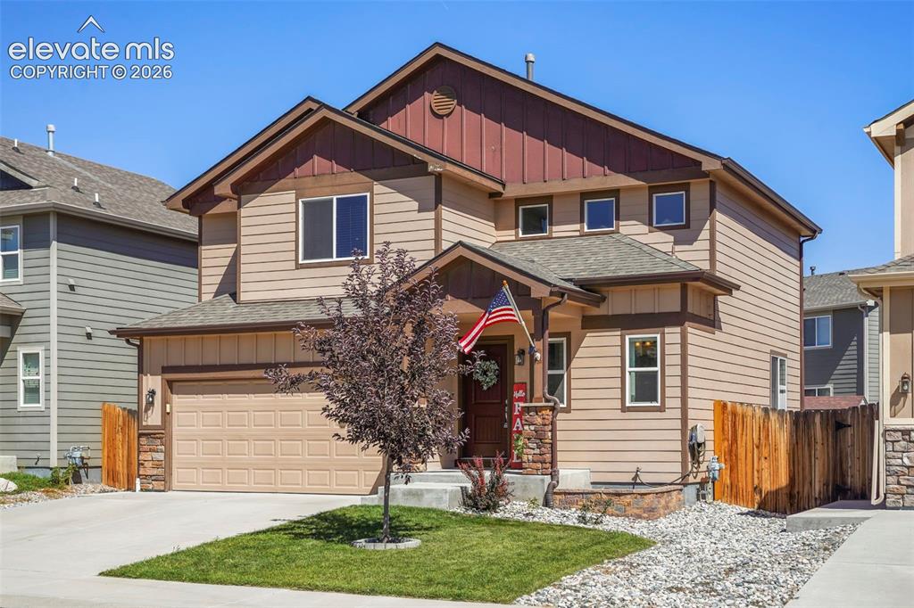 Image 28 of 32: Two-story residence featuring composite siding, an attached two-car garage,