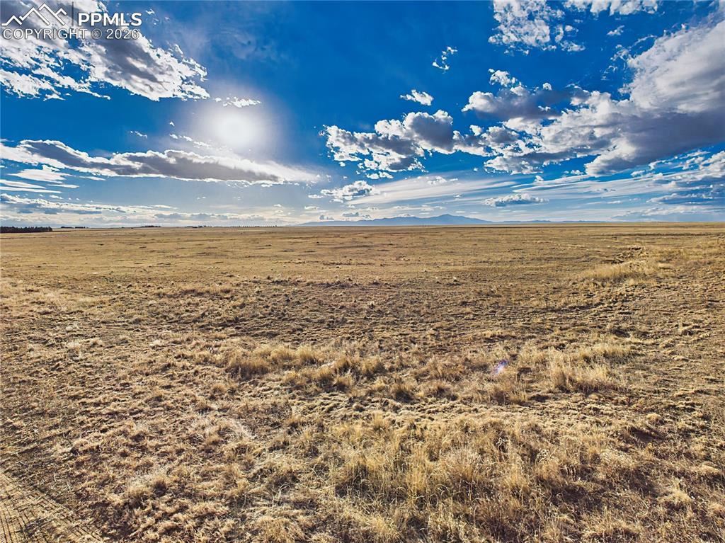 Image 2 of 6: This 3.02-acre corner parcel showcases rolling native grassland framed by d
