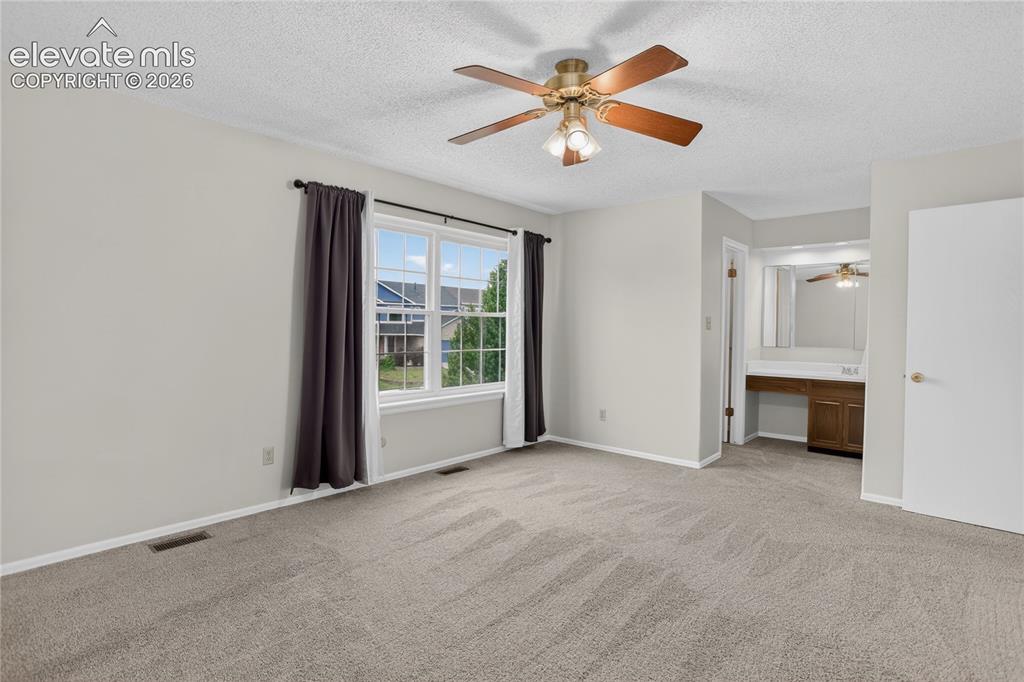 Image 11 of 21: Walk-in closet & full en-suite bath