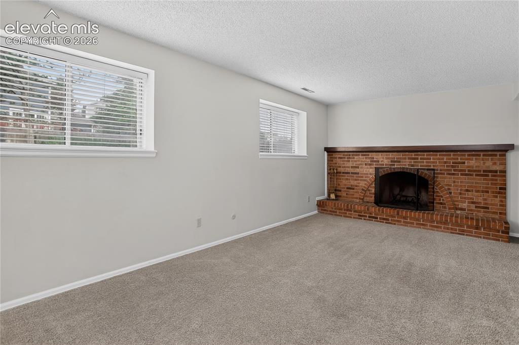 Image 8 of 21: Family room w/ gas fireplace - lower level