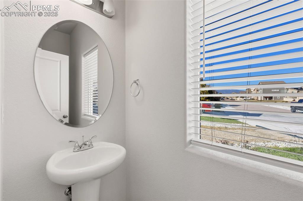 Image 10 of 35: Bathroom with a textured wall and healthy amount of natural light