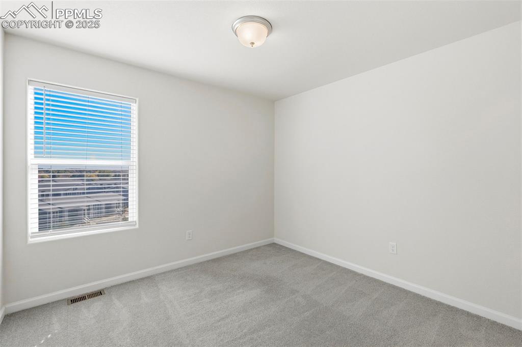 Image 17 of 35: Unfurnished room featuring light carpet and baseboards