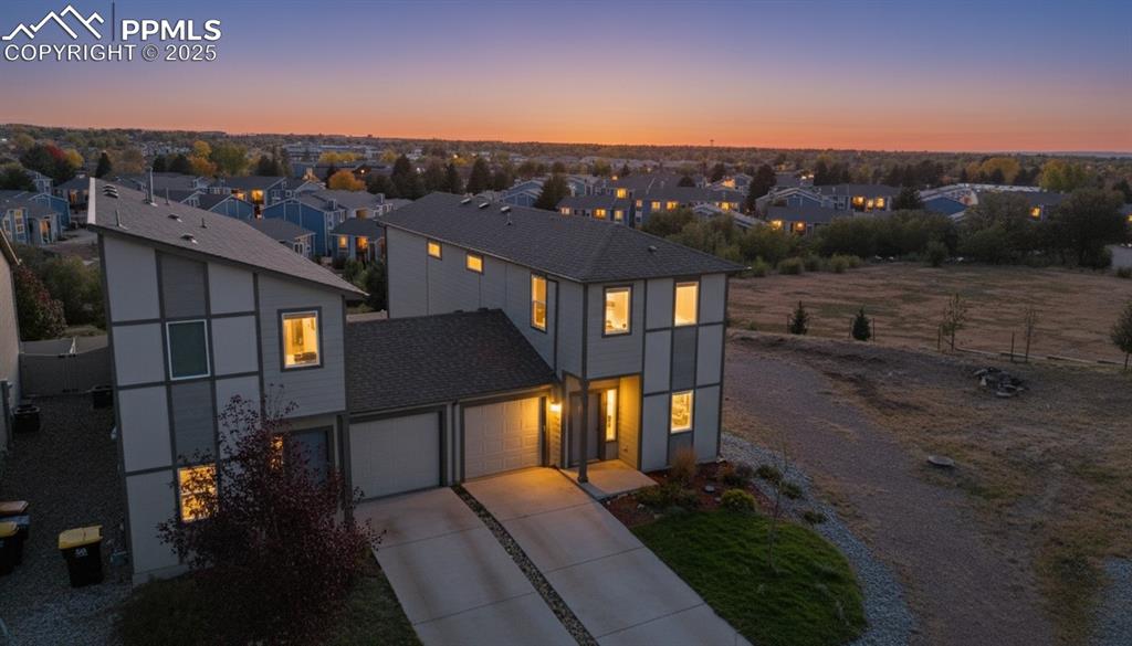 Image 2 of 35: Contemporary house with a residential view, concrete driveway, and a garage