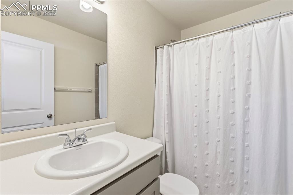 Image 21 of 35: Full bath featuring vanity and curtained shower