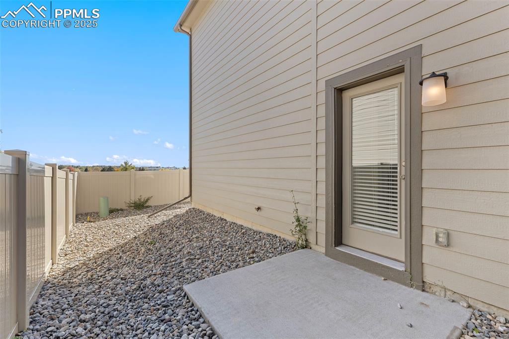 Image 27 of 35: View of exterior entry with a patio