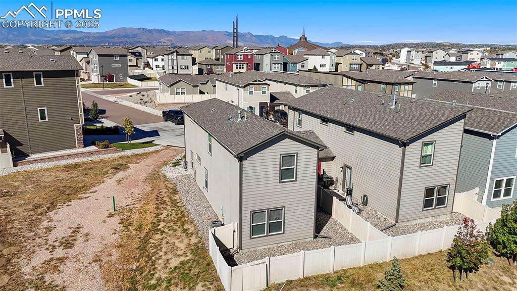 Image 29 of 35: Aerial perspective of suburban area with mountains