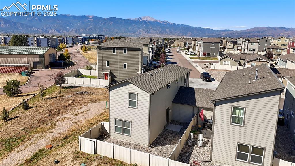 Image 31 of 35: Aerial view of residential area featuring a mountain backdrop