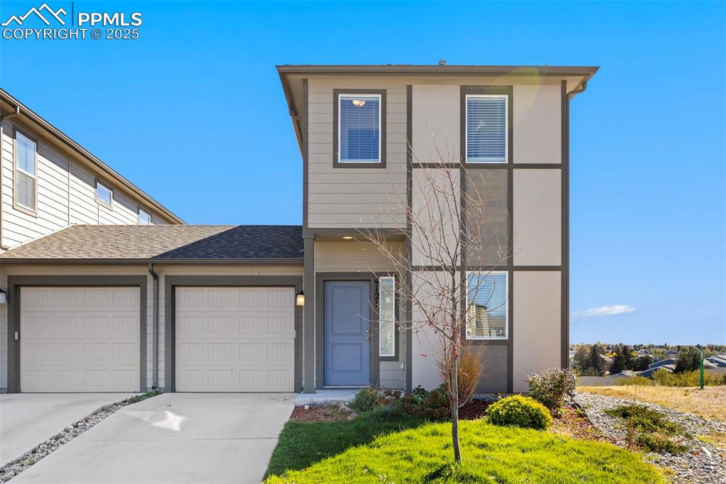 Image 4 of 35: View of front of house featuring driveway, a garage, a shingled roof, and a