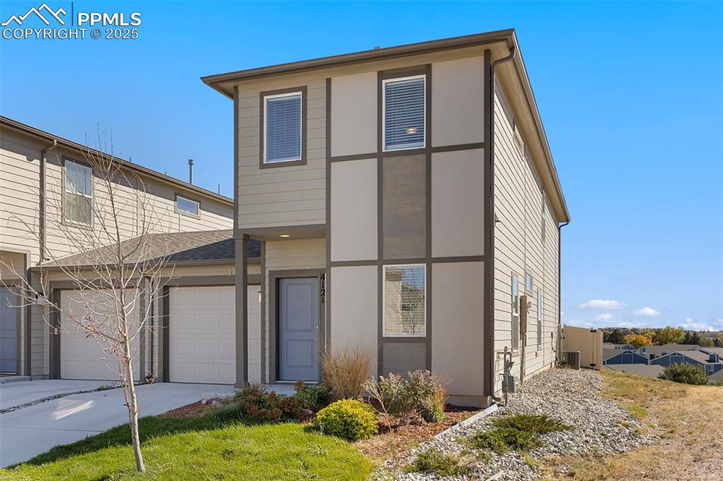 Image 5 of 35: View of front of house featuring concrete driveway