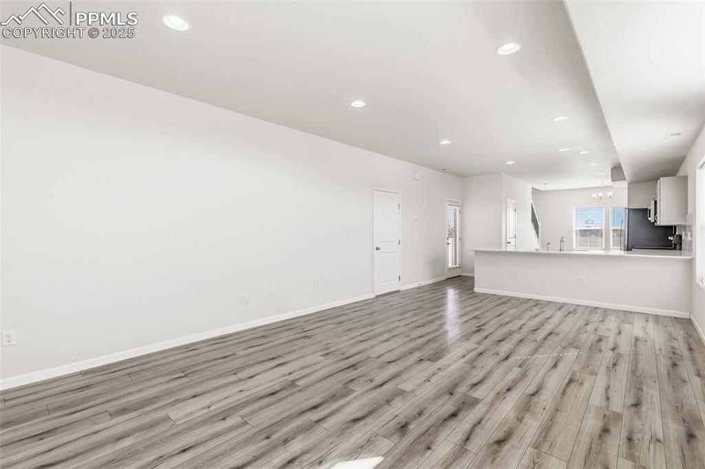 Image 7 of 35: Unfurnished living room featuring recessed lighting and light wood-style fl