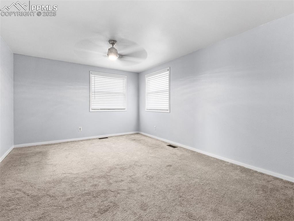 Image 24 of 29: Empty room featuring carpet and a ceiling fan