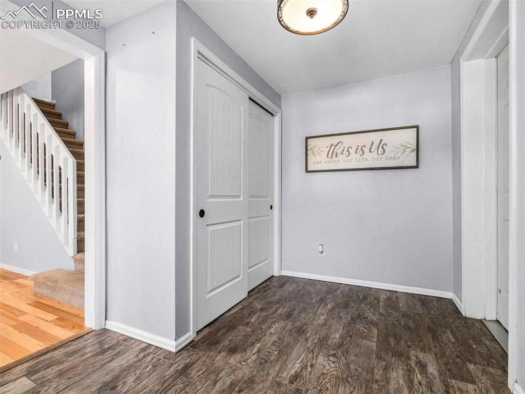 Image 3 of 29: Hallway featuring dark wood-style flooring and stairs