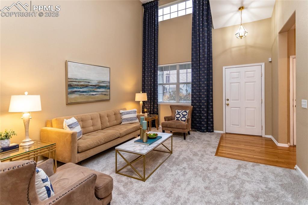 Image 18 of 40: Living area with a tall ceilings.