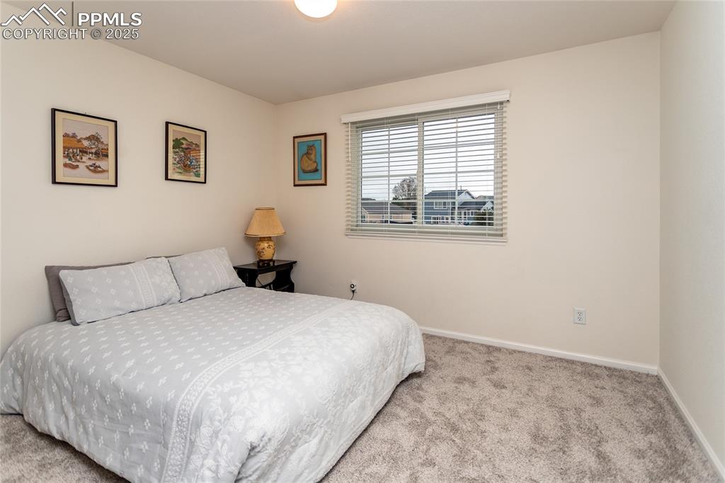 Image 25 of 40: Carpeted bedroom with baseboards