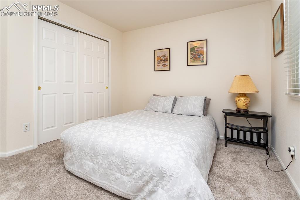 Image 26 of 40: Bedroom with carpet flooring, a closet, and baseboards