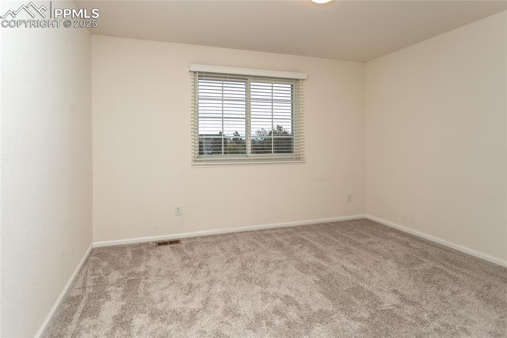 Image 27 of 40: Carpeted spare room with baseboards