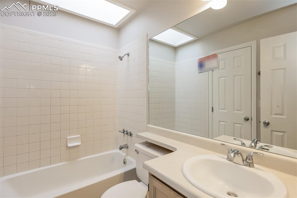 Image 16 of 25: Full bathroom with bathtub / shower combination, toilet, and vanity