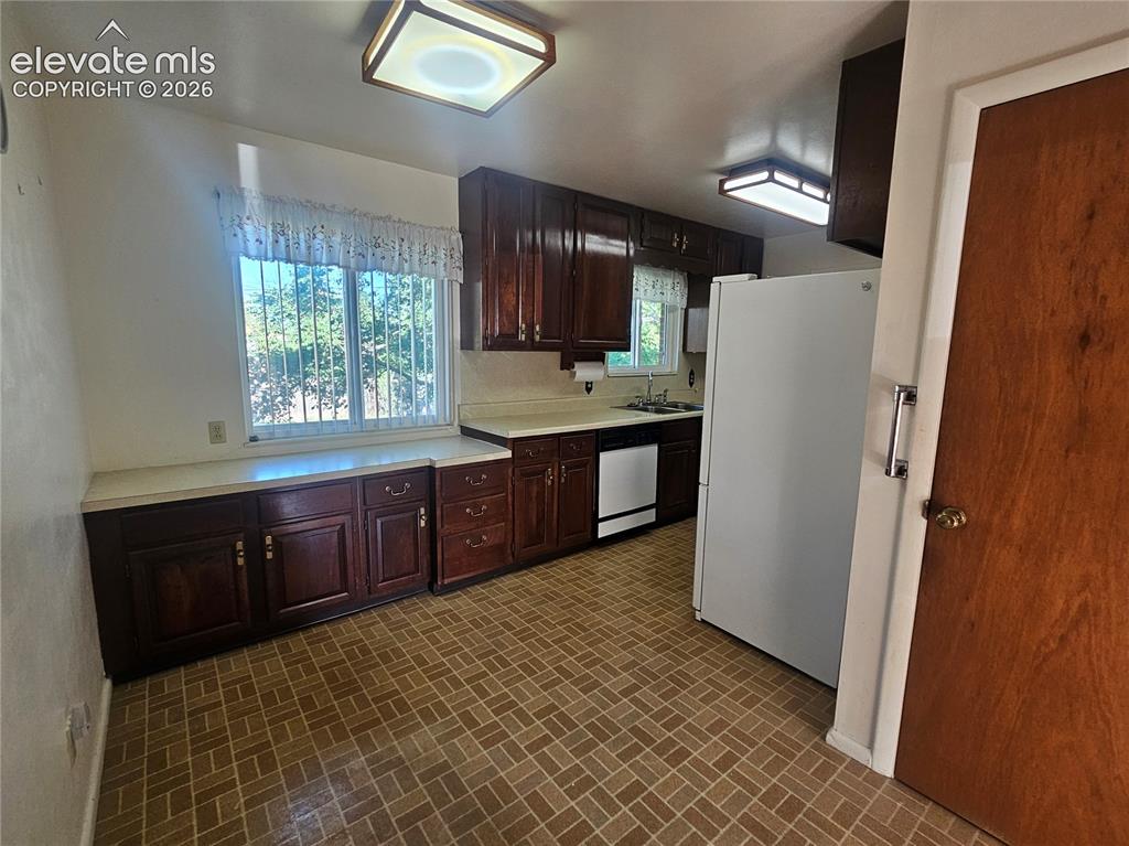Image 12 of 37: Kitchen wood cabinetry, light-toned countertops