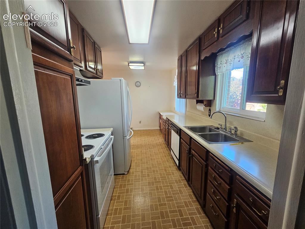 Image 14 of 37: kitchen with wood cabinetry. All appliances included.