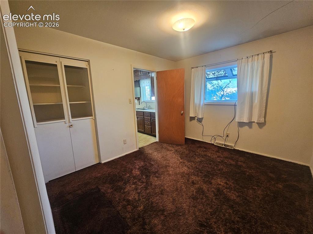 Image 16 of 37: Dining room w/ Built-in cabinetry with glass panel doors, and a showcase wi