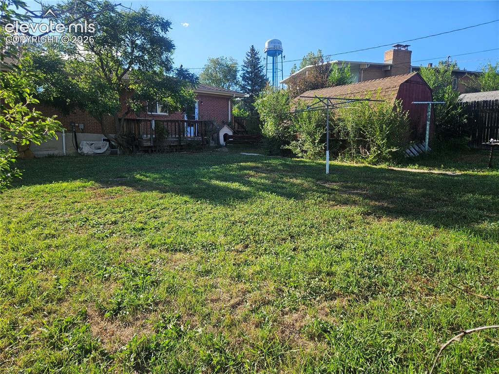 Image 34 of 37: Expansive backyard and wood storage shed