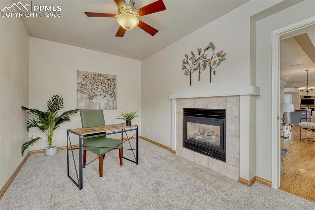 Image 16 of 47: Main level office with 2 way fireplace, large windows and door!