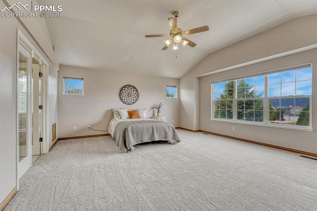Image 18 of 47: EXPANSIVE primary bedroom with sweeping Front Range and Pikes Peak Views!