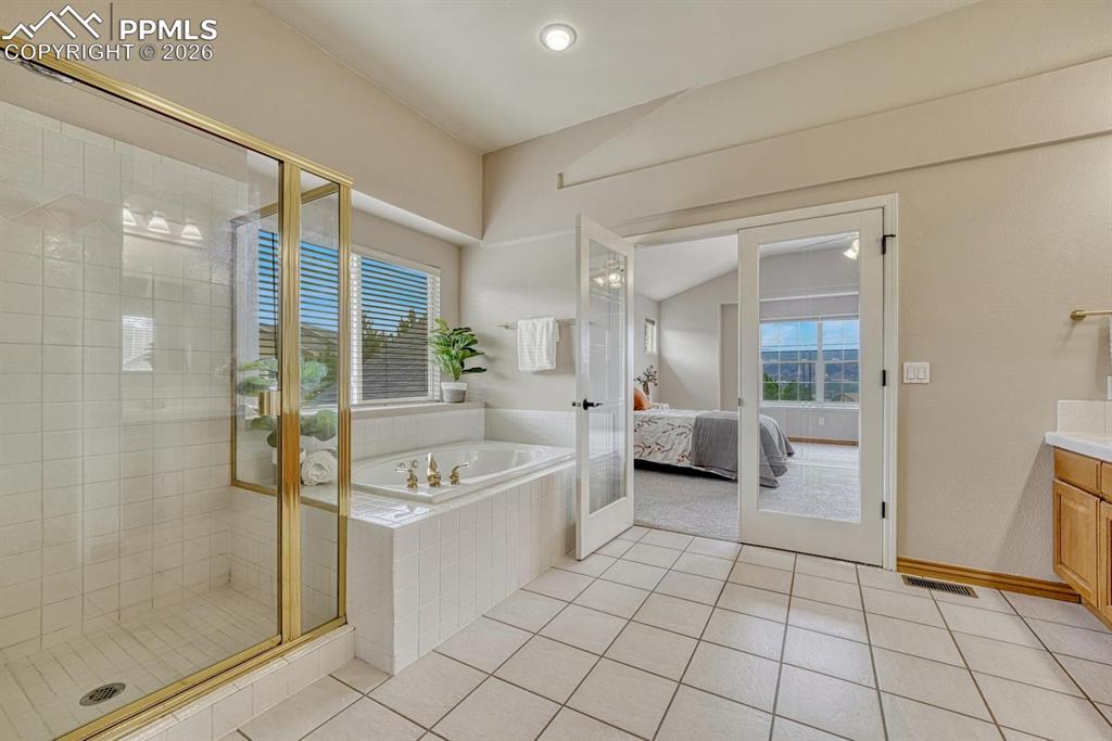 Image 22 of 47: Generous Primary 5 piece SPA adjacent to Primary Bedroom with vaulted ceili