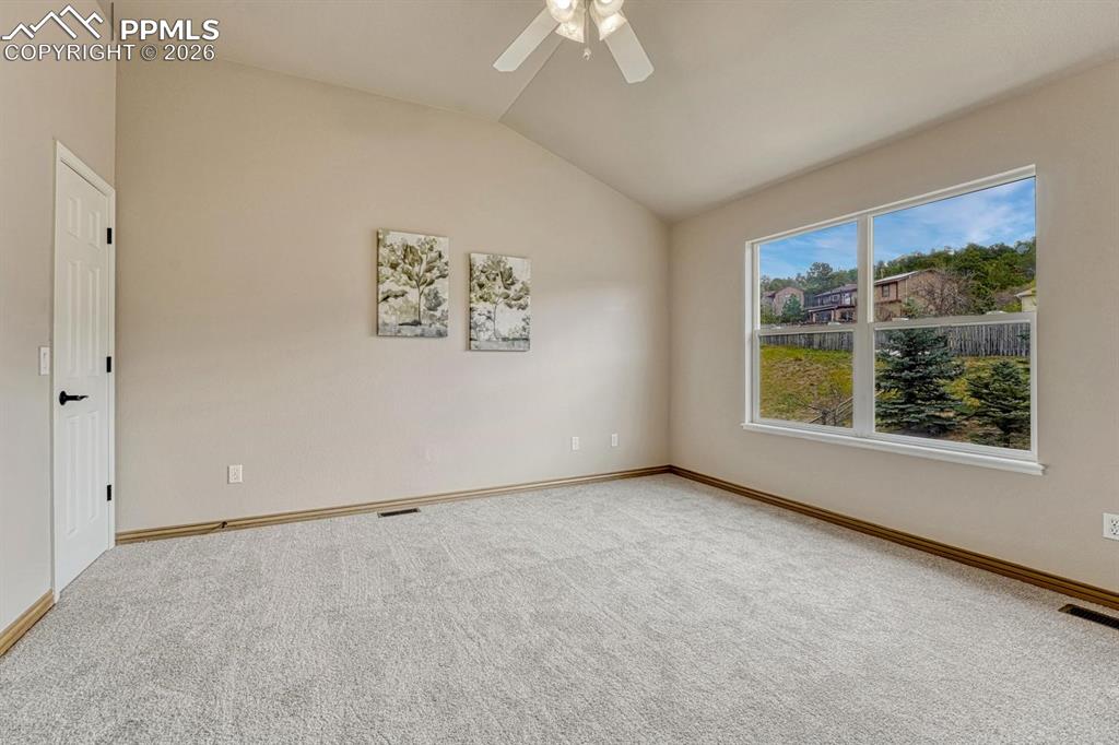 Image 28 of 47: Spacious upper level secondary bedrooms with vaulted ceilings and natural l
