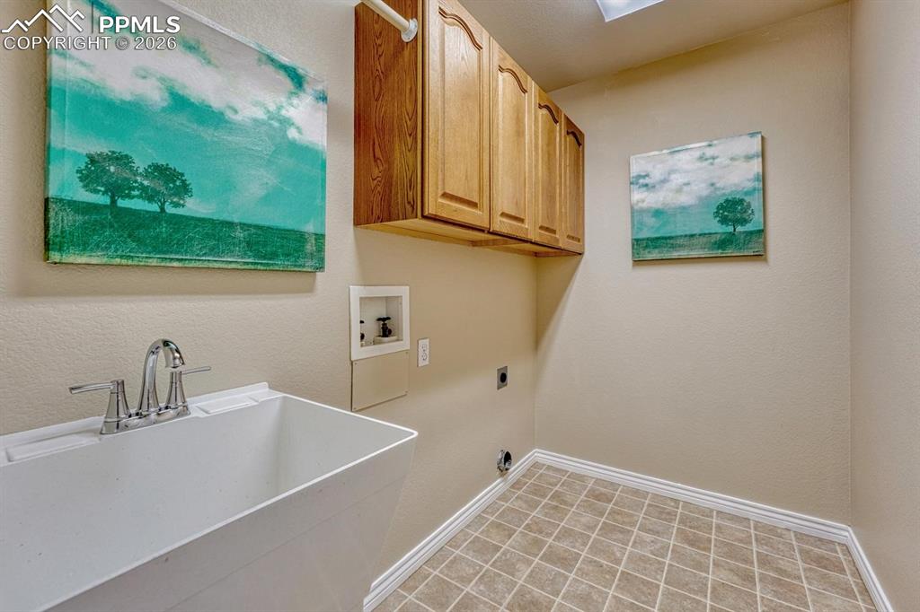 Image 39 of 47: Main Level laundry with storage and sink