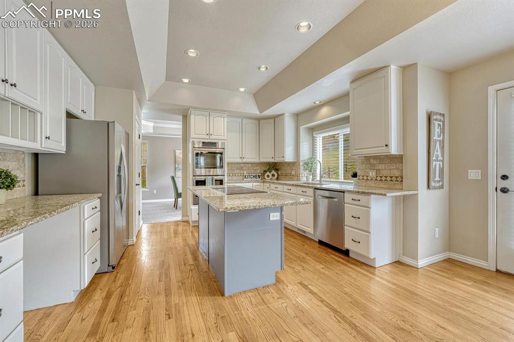 Image 9 of 47: Spacious kitchen with white cabinets, granite and stainless appliances!