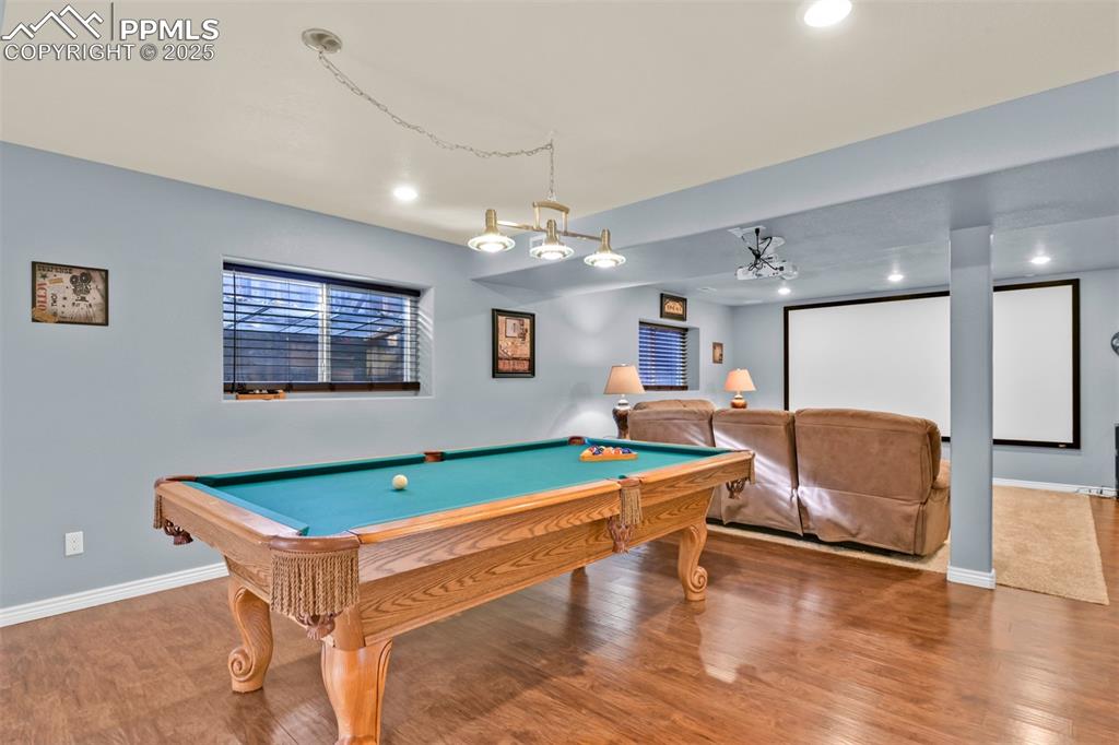Image 36 of 50: Game room with wood finished floors, billiards table, and recessed lighting