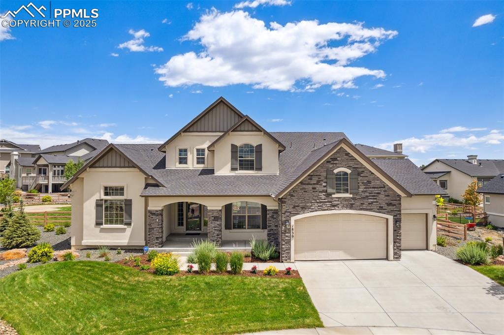 Caption: Stunning home featuring beautiful landscaping, covered porch, and 3-car garage
