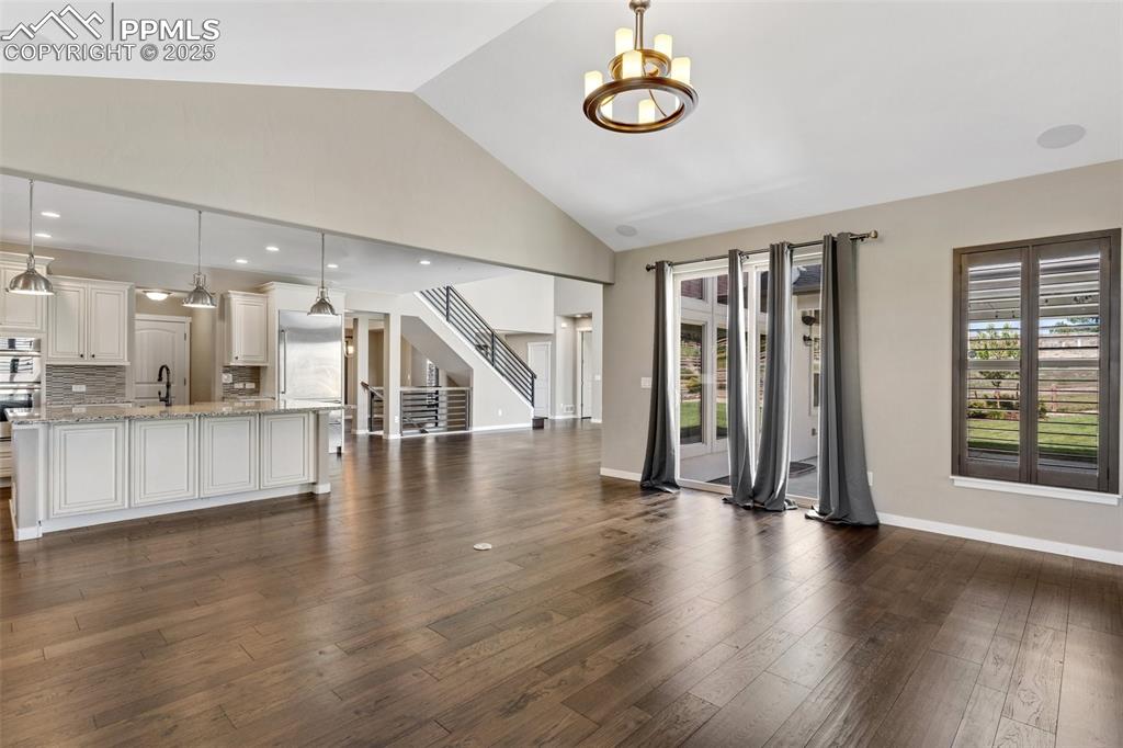 Image 22 of 49: Dining area featuring vaulted ceiling and access to patio