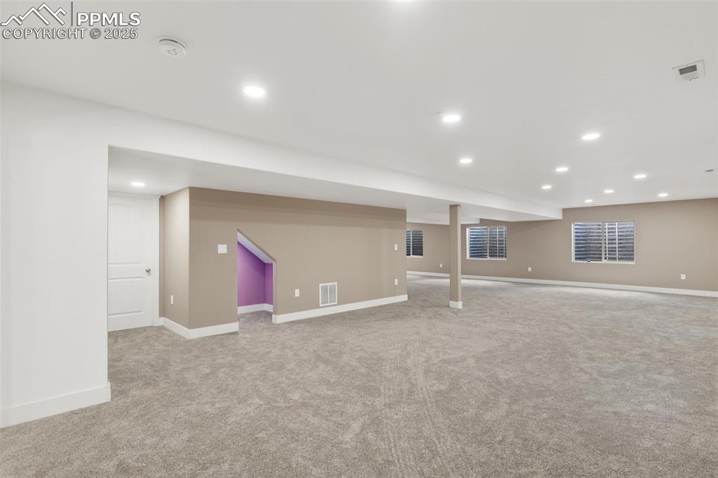 Image 34 of 49: Cubby under the stairs perfect for a reading nook or additional storage