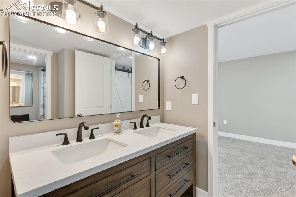 Image 37 of 49: 3/4 Jack-and-Jill bathroom featuring a double vanity