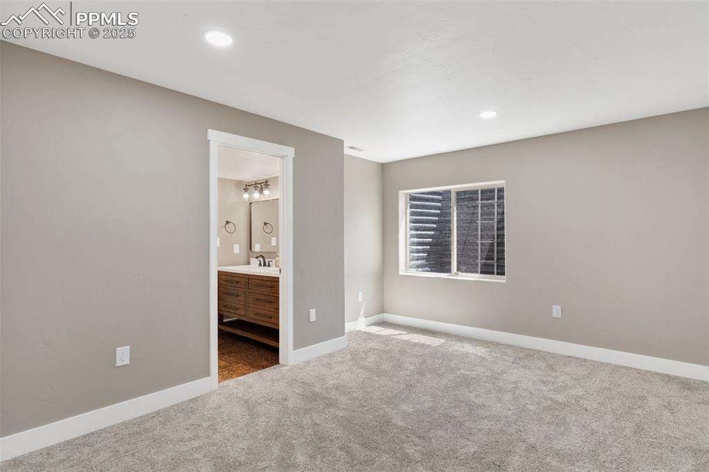 Image 38 of 49: Bedroom featuring a closet with a barn door and ensuite Jack-and-Jill bathr