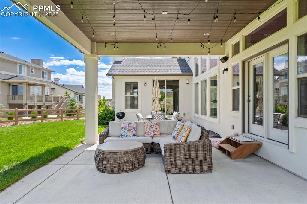 Image 45 of 49: Covered patio is perfect for rain or shine